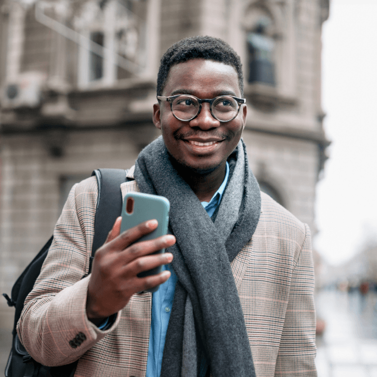A man stood outside whilst on his mobile phone